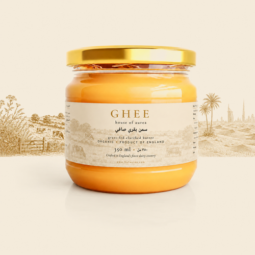 Labelled jar of House of Aurea West Country Ghee on parchment, with an engraved English pasture and Gulf skyline behind it